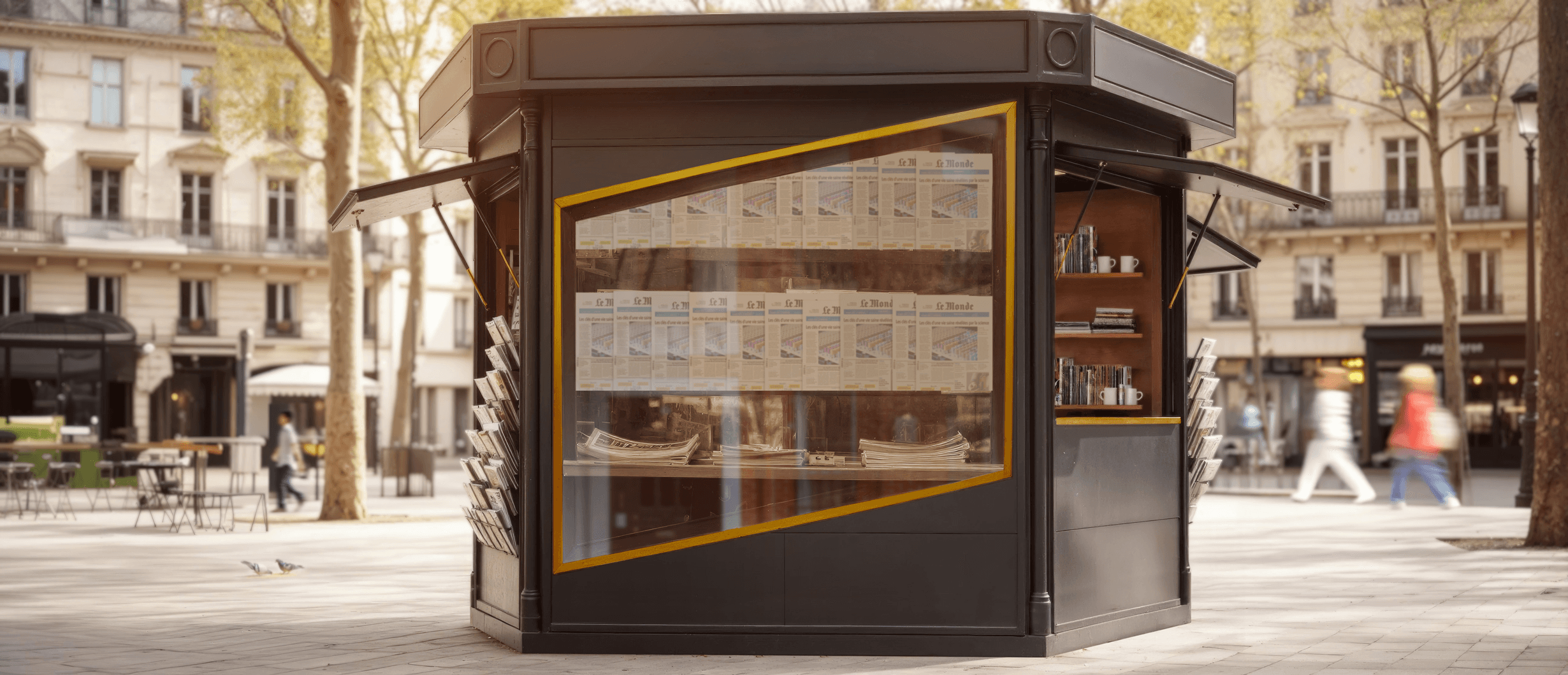 Street view of a traditional Parisian newspaper kiosk with yellow-framed windows displaying publications, where the window frame forms Stripe's parallelogram logo.